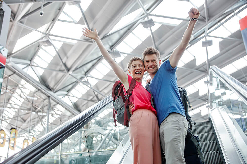 Excited travellers heading to their departure gate